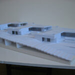 Josep Llinás’s House Model 3 showcasing a detailed scale model with composite materials, featuring a minimalist design and integrated daybed visible in the architectural plan.