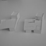 Josep Llinás’s House Model 4 showcasing a minimalist design with clean lines, a combination of paper and plastic materials, and distinct shadow play highlighting its geometric form.