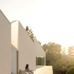 Nuno Brandao Costa’s Pura Comporta showcasing minimalist design with sandy textures and dynamic shadow play on the façade.