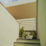 Casa Veiga / Casa Portufornia, Colares by Manuel Tainha, Rui Costa Martins (3762) Manuel Tainha and Rui Costa Martins' Casa Veiga / Casa Portufornia showcasing an interior with plaster walls, composite material ceiling, stairs, and ample daylighting highlighting modern architectural design.
