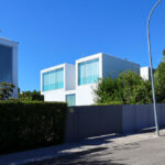 Francisco Aires Mateus’s Utopia Villa 1 showcasing minimalist white concrete walls with large windows designed for optimal daylighting.