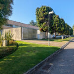 "Quinta da Barca Row House 1 "" Casa do Pinhal"" ", Esposende by João Alvaro Rocha (3726) João Alvaro Rocha’s Casa do Pinhal showcasing a modern suburban public space with a shaded walkway, asphalt sidewalk, landscaped trees, and a tar path integrated into the design.