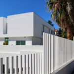 Unknown Architect’s Utopia Villa 16 showcasing a modern residential facade with composite materials, concrete balconies, engineered shading elements, and a spacious estate setting.
