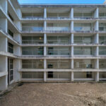 Vítor Figueiredo’s Escola Superior de Artes e Design showcasing a high-rise building with concrete and composite materials, featuring glass balconies and extensive daylighting elements.