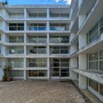 Vítor Figueiredo’s design of Escola Superior de Artes e Design showcasing a high-rise concrete and glass building with multiple balconies and extensive daylighting features.