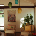 Casa Veiga / Casa Portufornia, Colares by Manuel Tainha, Rui Costa Martins (3773) Casa Veiga by Manuel Tainha and Rui Costa Martins showcasing an interior design with natural wood-stained ceiling, modern light fixtures, glass elements, and warm lighting from lampshades.