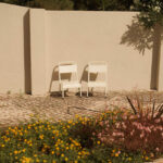 Casa Veiga / Casa Portufornia, Colares by Manuel Tainha, Rui Costa Martins (3794) Casa Veiga by Manuel Tainha and Rui Costa Martins showcasing a modern outdoor garden with landscaped backyard, outdoor furniture including chairs with armrests, shaded areas, and natural shadows.