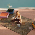 Casa Veiga / Casa Portufornia, Colares by Manuel Tainha, Rui Costa Martins (3785) Casa Veiga by Manuel Tainha and Rui Costa Martins showcasing a modern outdoor space with natural material wicker furniture, linens, and a textured mat on a rug.