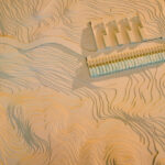 Gonçalo Byrne’s design of "6 Unbuilt Villas, Lot 209" showcasing wooden structural elements with hardwood and plywood materials casting dynamic shadows.