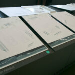 Rui Passos’ design of "7 Architectural The Ken Houses Villas, Lot 41" showcasing a modern structure with transparent glass façades, geometric paper-like paneling, and sleek office-inspired graphic elements.