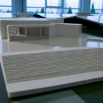 Álvaro Siza Vieira’s 14 Architectural Villas, Lot 1, showcasing a detailed scale model with transparent composite materials highlighting interior design elements, flooring, and daylighting features.