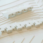 Atelier dos Remédios, Madalena Cardoso de Menezes and Francisco Teixeira Bastos' 18 Red Architectural Townhouses, Lot 215, showcasing a detailed scale model with paper plans and plastic elements highlighting the townhouse layout and design.