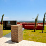 Nuno Graça Moura’s Tennis Club, Lot 161, showcasing landscaped gardens with artificial turf lawns and modern outdoor seating areas.