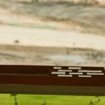 Gonçalo Byrne’s "6 Unbuilt Villas, Lot 209" showcasing a modern design with wood and composite material cladding, featuring hardwood planks and dynamic shadow patterns.