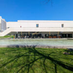 Alcino Soutinho’s Biblioteca Municipal Florbela Espanca showcasing a modern public space with a composite material façade, shaded courtyard, and integrated community centre design.