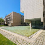 Alcino Soutinho’s Biblioteca Municipal Florbela Espanca showcasing a modern urban design with composite materials, a reflecting pool, and extensive daylighting features.