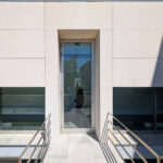 Alcino Soutinho’s Biblioteca Municipal Florbela Espanca showcasing a modern concrete and composite material structure with large glass panels, grey tiled surfaces, and engineered daylighting features.