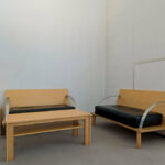 Alcino Soutinho’s Biblioteca Municipal Florbela Espanca interior showcasing wood flooring, hardwood furniture, stained wood chairs, and a warm, inviting room design.