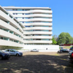 Alcino Soutinho’s Conjunto Residencial Varandas de Venezuela showcasing a high-rise condominium with modern glass façades and balconies overlooking the cityscape.