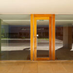 Alcino Soutinho’s Conjunto Residencial Varandas de Venezuela showcasing wooden walls and doors with rich wood stain, hardwood flooring, and varnished finishes highlighting natural building materials.