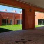 Alcino Soutinho's Department of Ceramics and Glass Engineering at the University of Aveiro showcasing brick and concrete walls with daylighting features and tiled flooring.
