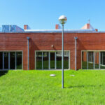 Alcino Soutinho's Department of Ceramics and Glass Engineering at the University of Aveiro showcasing brickwork, a courtyard, and daylighting elements on a campus setting.