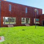 Alcino Soutinho's Department of Ceramics and Glass Engineering at the University of Aveiro showcasing brickwork walls, landscaped lawn, and modern building materials.