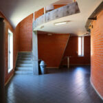 Alcino Soutinho's Department of Ceramics and Glass Engineering at the University of Aveiro showcasing an interior with wood ceiling, brown flooring, and metal building materials.