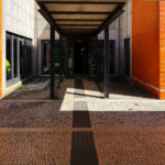 Alcino Soutinho's Department of Chemistry, University of Aveiro, showcasing a modern design with orange brickwork, metal accents, and expansive glass walls.