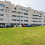 Alcino Soutinho’s Edifício Delfim Pereira da Costa showcasing a high-rise mixed-use commercial and residential building with a sleek glass façade and modern urban design elements in a metropolitan cityscape.