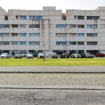 Alcino Soutinho’s Edifício Delfim Pereira da Costa showcasing a high-rise mixed-use commercial and residential building with composite material façade, large glass windows, and modern urban design elements.