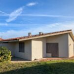Alcino Soutinho's Holiday House in Praia de Suave-Mar showcasing a sloped roof and garden buildings in a rural area with a cottage-like appearance.