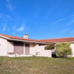 Alcino Soutinho's Holiday House in Praia de Suave-Mar showcasing a modern residential design with a prominent roof, distinct facade, and integration into the surrounding estate.