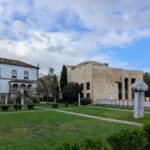 Alcino Soutinho's Matosinhos Town Hall showcasing a historic house design with a grand estate, manicured lawn, and villa-like structure surrounded by a park.