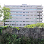 Alcino Soutinho’s Quinta das Sedas showcasing a high-rise condominium with a composite material façade, brutalist architectural elements, and urban design features under daytime lighting.