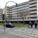 Alcino Soutinho’s Quinta das Sedas showcasing a modern apartment complex with a sleek glass façade, integrated public spaces, and contemporary urban design elements in a metropolitan area during daytime.