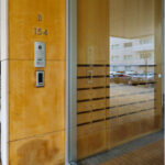 Alcino Soutinho’s Quinta das Sedas showcasing a modern wooden interior with hardwood flooring, stained wood doors, composite materials, and large glass panels.