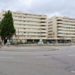 Alcino Soutinho’s Quinta das Sedas showcases a modern high-rise mixed-use building with a sleek glass façade, integrated urban design elements, and a prominent commercial and residential condominium structure in a metropolitan city setting.