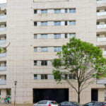 Alcino Soutinho’s Quinta das Sedas showcasing a high-rise residential and commercial building with a modern glass façade and urban condominium design in a metropolitan area.