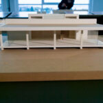 Gonçalo Cardoso de Menezes’ Former Sales Office, Lot 165, showcasing a scale model with hardwood flooring and plywood elements illuminated by natural daylighting.