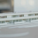 Atelier dos Remédios, Madalena Cardoso de Menezes, and Francisco Teixeira Bastos’ 18 Architectural Townhouses, Lot 215, showcasing a modern design with clean lines, engineered structural elements, and a combination of glass façades and geometric assemblies.