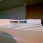 Eduardo Souto de Moura’s 13 Architectural "C-Shaped" Villas, Lot 101, showcasing modern interior design with composite flooring, transparent elements enhancing daylighting, and distinctive C-shaped architectural forms creating dynamic shadows.