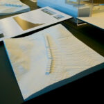 Gonçalo Cardoso de Menezes’ 21 Architectural Townhouses, Lot 154, showcasing a series of modern townhouses with transparent glass façades, sharp shadows, and layered paper-like graphic elements emphasizing structural transparency.