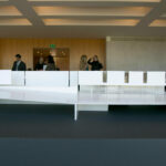 Gonçalo Byrne’s "6 Unbuilt Villas, Lot 209" interior showcasing a clean conference room with composite flooring, modern furniture including chairs and a large desk under a sleek ceiling.