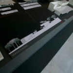 Gonçalo Byrne’s architectural plan for "6 Unbuilt Villas, Lot 209" showcasing detailed design graphics with transparent overlays highlighting structural layouts and spatial organization.