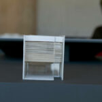 Gonçalo Byrne’s 25 Architectural Townhouses "Rusty Gates," Lot 217, showcasing a modern design with grey and silver tones, featuring sleek plastic elements and a minimalist façade.